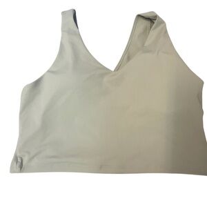 Light green sports bra/crop top, you decide. Cross cross back and thick straps.